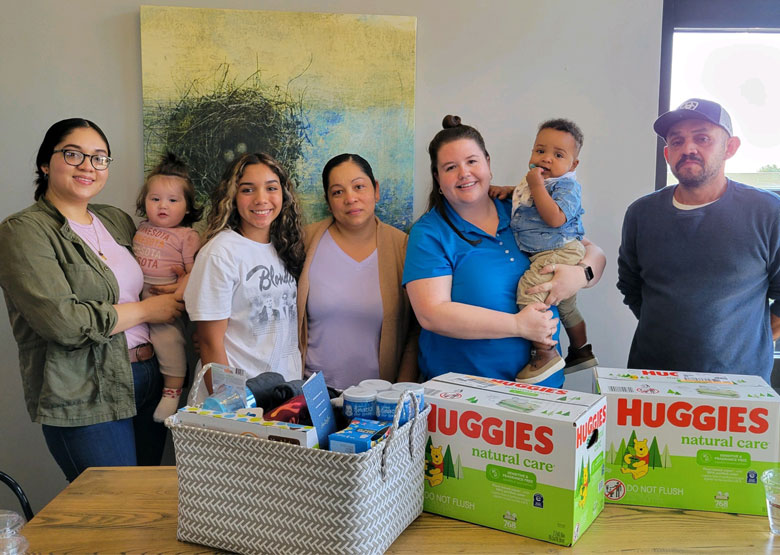 family gathered behind a table