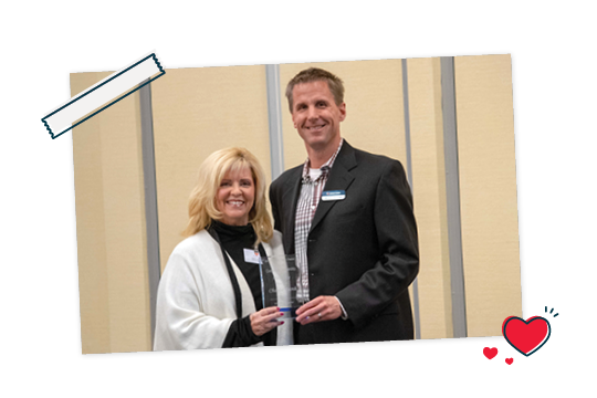 CEO, Brian Johnson being presented an award.