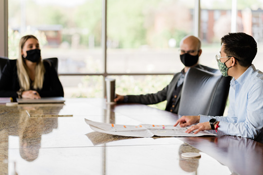 people in masks meeting