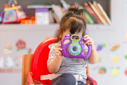 Child playing with camera