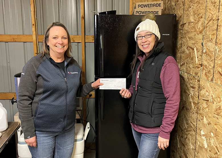 Two women in front of a fridge