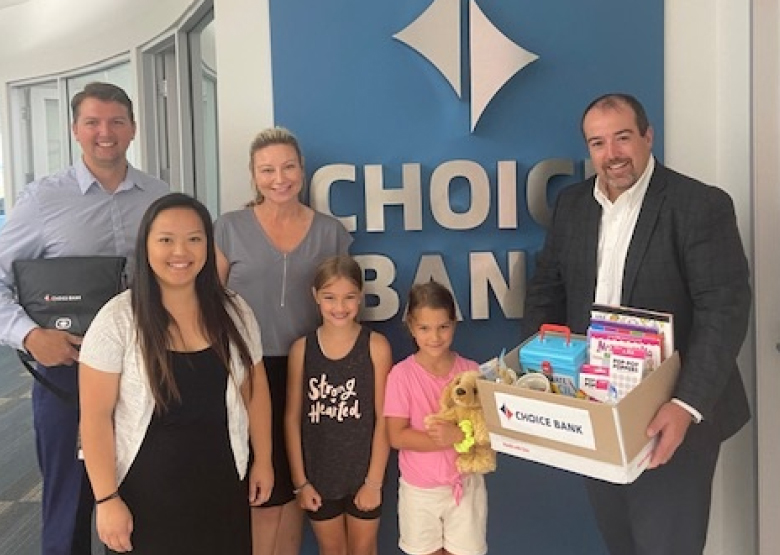 Adults give girl stuffed animal