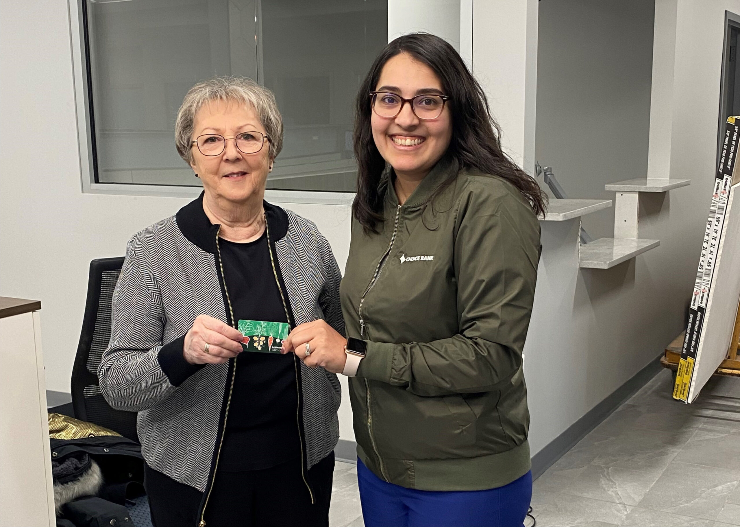 two women holding a gift card