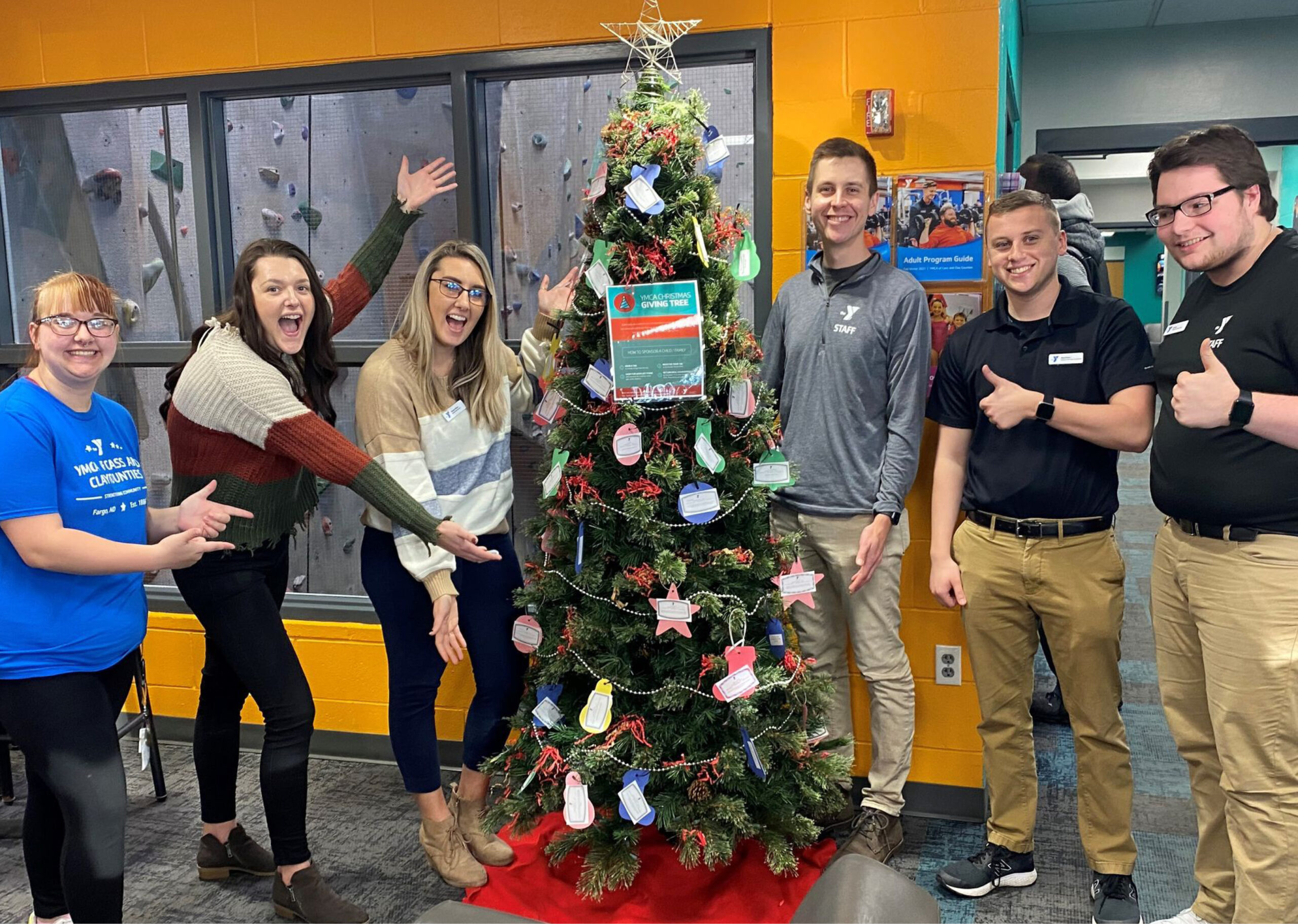 People Stand Around the YWCA Giving Tree